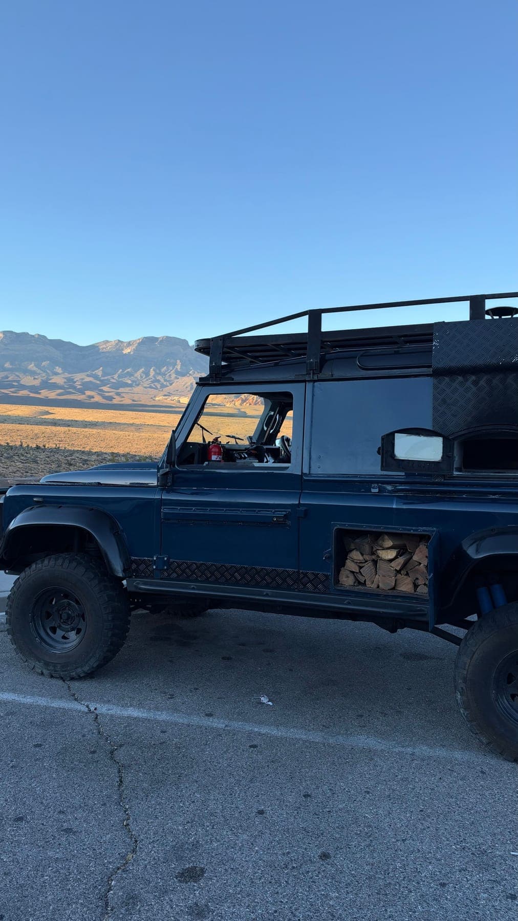 The truck side-on with the desert and mountains behind